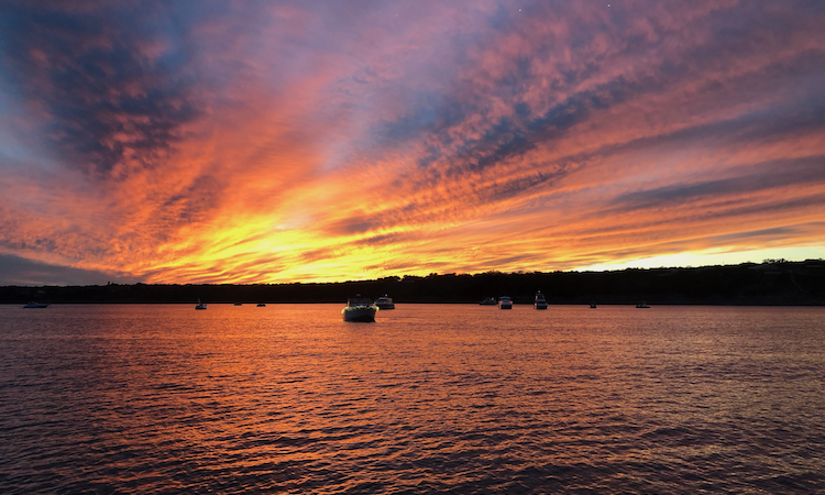 sunset on lake travis with boats